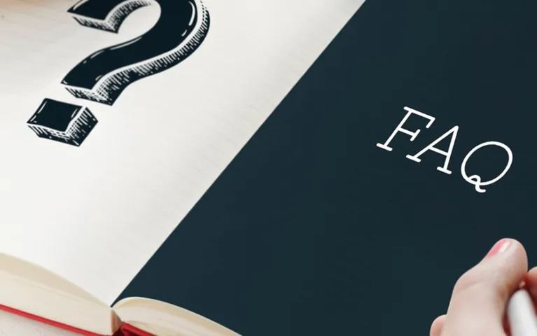 Open book with a large question mark on one page and "FAQ" text on the opposite page.